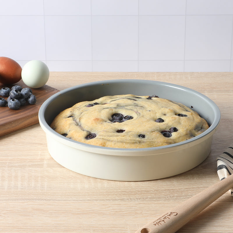 Sur la Table Kitchen Essentials Bake Sale 9" Carbon Steel Cake Pan - Eggshell - Grey Nonstick Interior - Color Label - Round