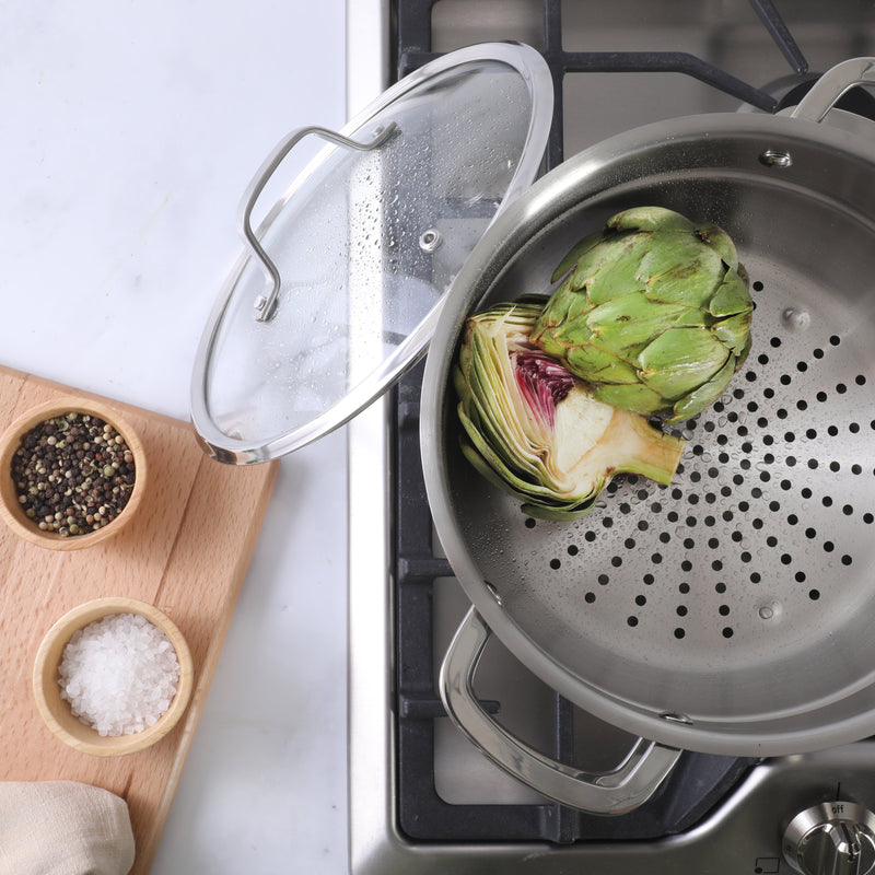 Sur La Table Kitchen Essential Chef's Deck 5.3 qt Stainless Steel Dutch Oven w/ Steamer & Glass Lid - Polish Exterior - Impact Bonded Base - Induction - Stainless Steel Hollow Handle - Color Sleeve w/ Remailer